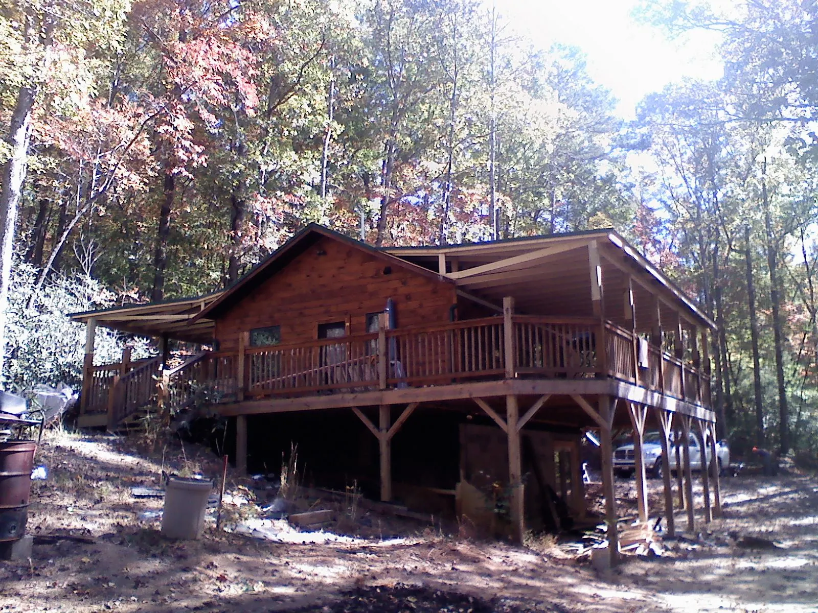 Log cabin with a wraparound porch and metal roof in the fall in Universal City
