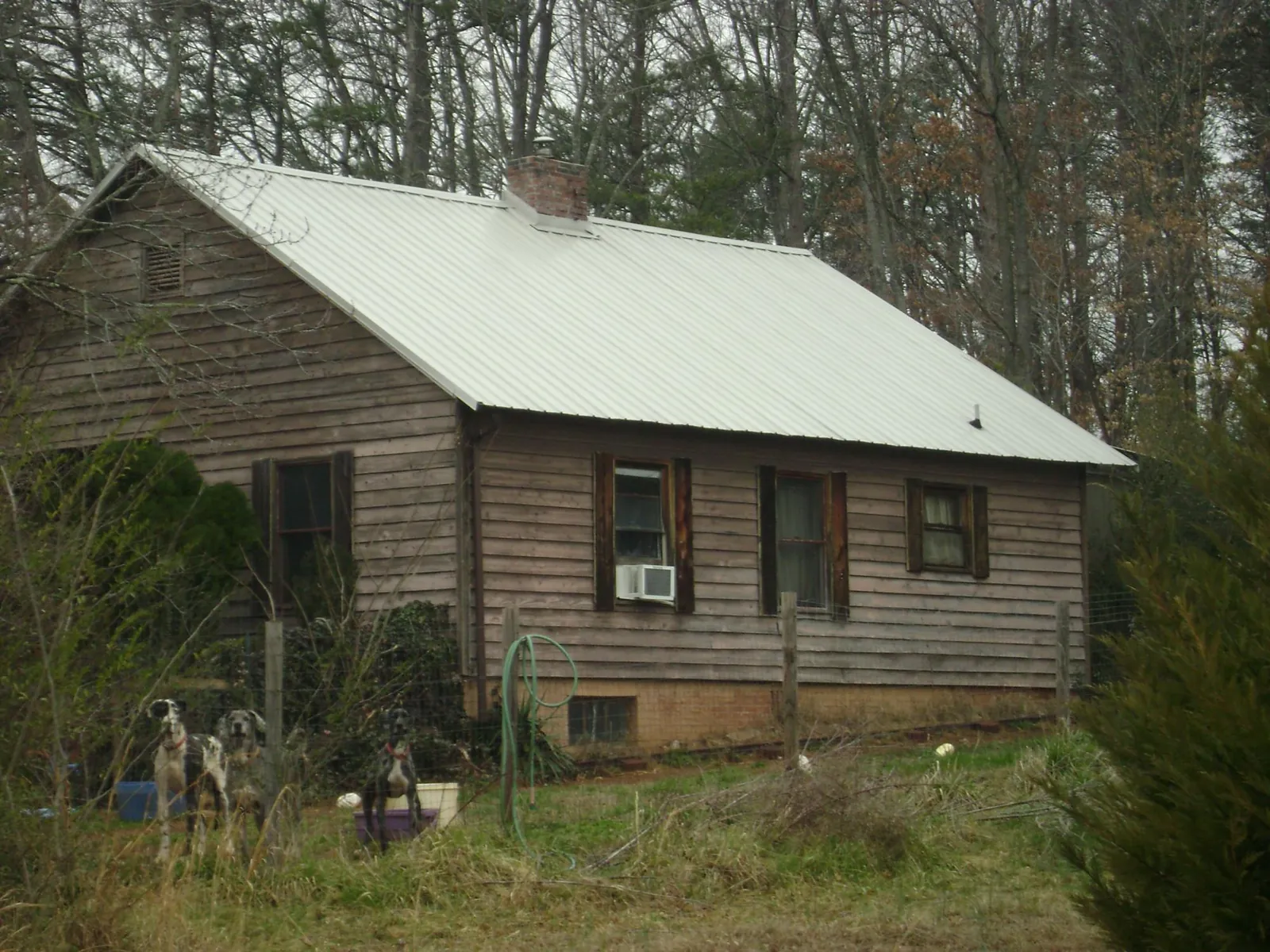 White metal roof on an old wood sided farmhouse, from a Metal Roof Installation job in Universal City
